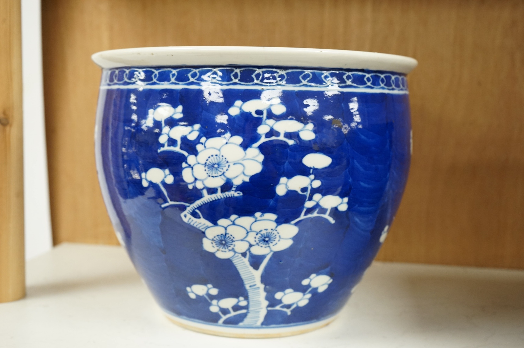A Chinese blue and white ‘prunus’ jardiniere, 20cm tall. Condition- chipped